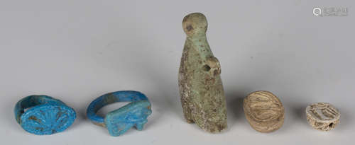 A group of five Ancient Egyptian artefacts, comprising two blue faience finger rings, New Kingdom