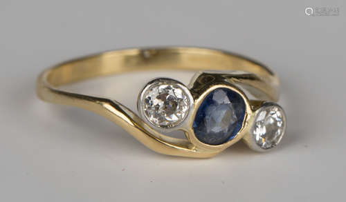 An 18ct gold, sapphire and diamond three stone ring, mounted with the oval cut sapphire between