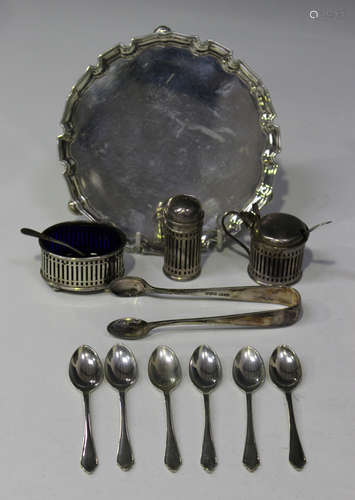 A George V silver circular card salver with piecrust rim, on scroll legs, London 1935 by Harrods