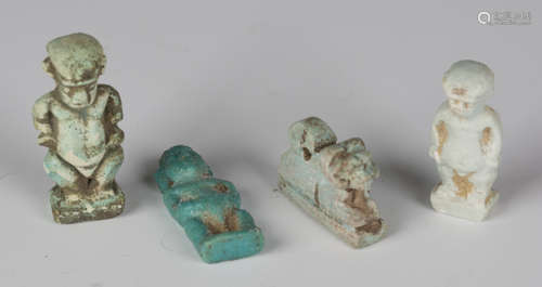 A group of four Ancient Egyptian green faience amulets, comprising three modelled as Pataichos,