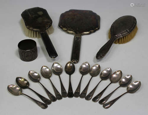 A set of twelve Continental silver teaspoons, a silver napkin ring and three silver mounted dressing