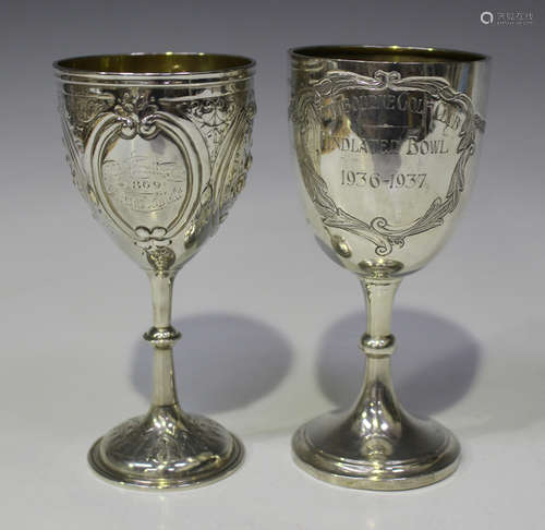 A late Victorian silver presentation goblet, decorated in relief and engraved with oval panels