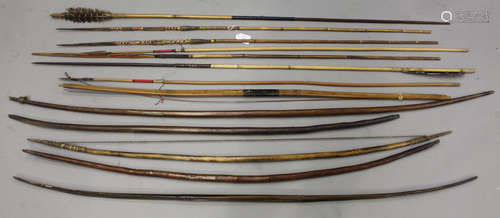 A collection of tribal bows and arrows, including Papua New Guinea examples.Buyer’s Premium 29.4% (