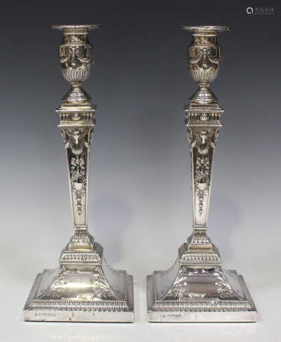 A pair of Victorian silver candlesticks, each with a beaded detachable nozzle and urn shaped