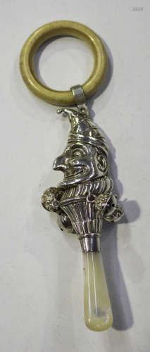 A George V silver child's rattle in the form of Punch, with mother-of-pearl handle and ivorine