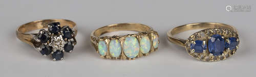 A 9ct gold and opal five stone ring, mounted with a row of graduated oval opals, a gold, sapphire