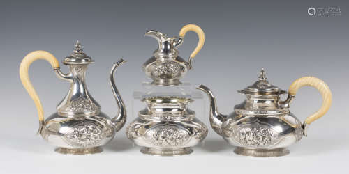 An early Victorian silver Persian style four-piece tea set, decorated in relief with floral panels