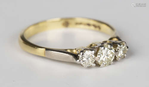 An 18ct gold and diamond three stone ring, mounted with a row of circular cut diamonds with the