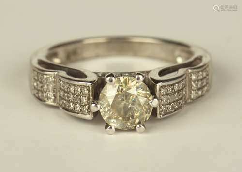 A white gold and diamond ring, claw set with the principal circular cut diamond between diamond