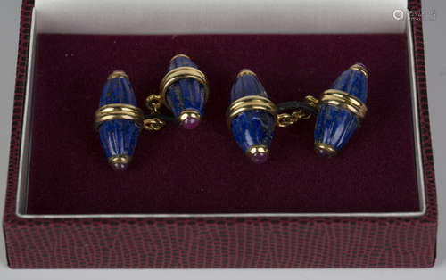 A pair of lapis lazuli and cabochon ruby cufflinks, each back and front of fluted barrel shape