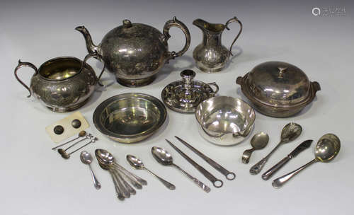 A group of plated items, including a three-piece tea set, a chamberstick and a muffin dish and