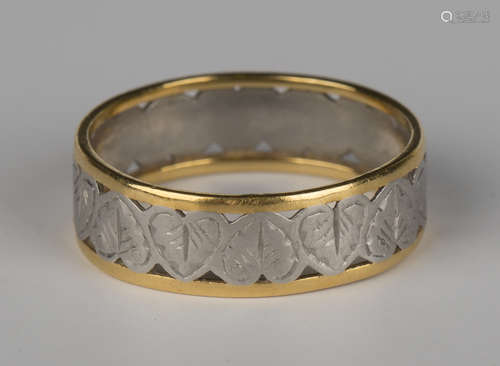 A platinum and gold wide band ring with pierced and engraved foliate decoration, ring size approx