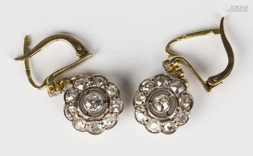 A pair of gold and diamond pendant earrings, each collet set with a principal circular cut diamond