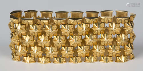 An 18ct gold wide bracelet in an open square floral link design, import mark London 1959, length