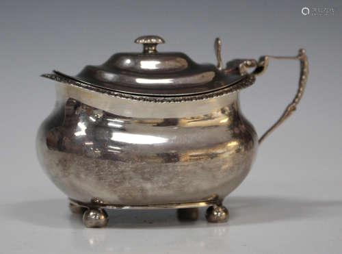 A George III silver mustard of cushion form with gadrooned rim and tappit hinged lid, raised on ball