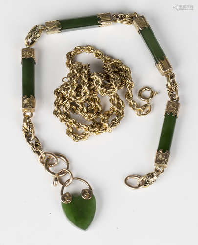 A gold mounted nephrite baton shaped link bracelet with a heart shaped pendant on a boltring