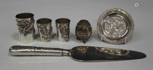 A group of three early 20th century Chinese silver shot measures or beakers, each decorated in