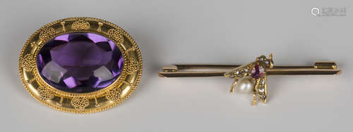 A gold brooch, mounted with an oval cabochon amethyst, width 2.5cm, and a rose cut diamond, ruby and