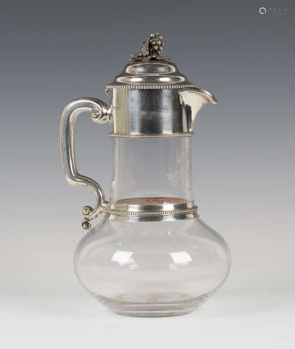 A Victorian silver mounted cut glass claret jug, the domed hinged lid with fruiting vine finial