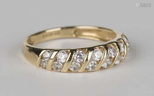 A 14ct gold and colourless gem set half-hoop ring, mounted with eight pairs of circular cut