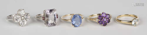 A 9ct gold and circular cut pale blue gem set solitaire ring, a 9ct gold ring claw set with an