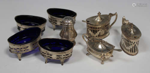 A matched set of four late Victorian silver oval pierced and engraved salts, on scroll legs, Chester