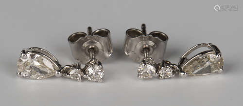 A pair of white gold and diamond pendant earrings, each claw set pear shaped diamond with a