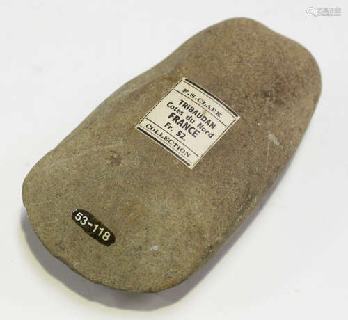 A small French Neolithic polished axe head, bearing 'F.S. Clark France Collection' label,