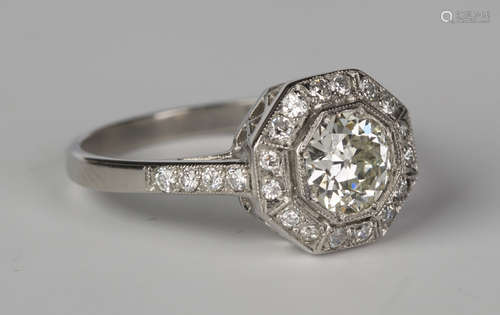 A platinum and diamond octagonal cluster ring, mounted with the principal circular cut diamond