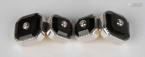 A pair of diamond set black onyx cufflinks, each with a cut-cornered square front and smaller