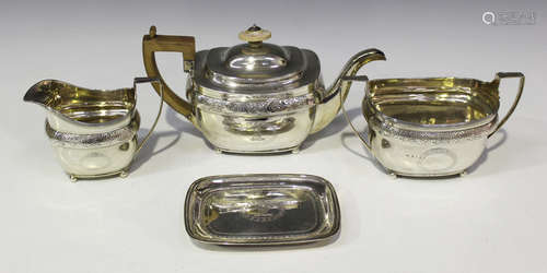 A George III silver three-piece tea set of cushion form, engraved with a crowned lion crest in an