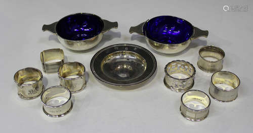 A pair of George V silver circular quaiches with tab handles, Birmingham 1926 and 1927 by Docker &