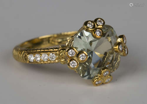 An American Judith Ripka gold, diamond and pale blue gem set ring, the cushion shaped blue gem