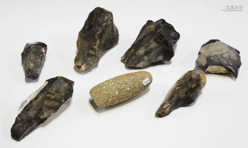 A group of six Palaeolithic hand axes and cleaver tools, together with a small pecked and polished