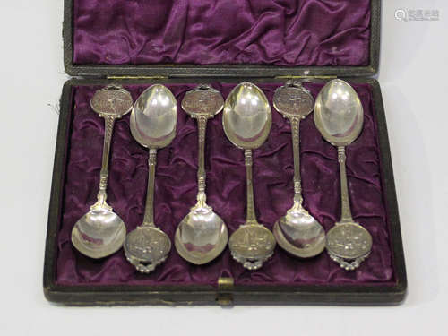 A set of six George V silver teaspoons, each circular terminal decorated in relief with a golfer and