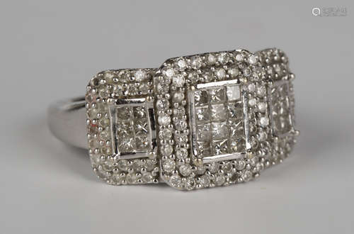 An 18ct white gold and diamond ring of geometric form, pavé set with princess and circular cut