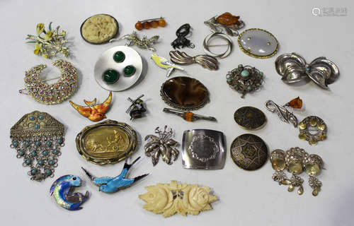 A collection of thirty brooches, including a sterling silver and enamel brooch, designed as a