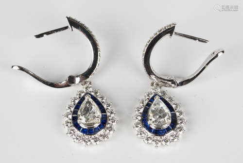 A pair of 18ct white gold, diamond and sapphire pendant cluster earrings, each mounted with a