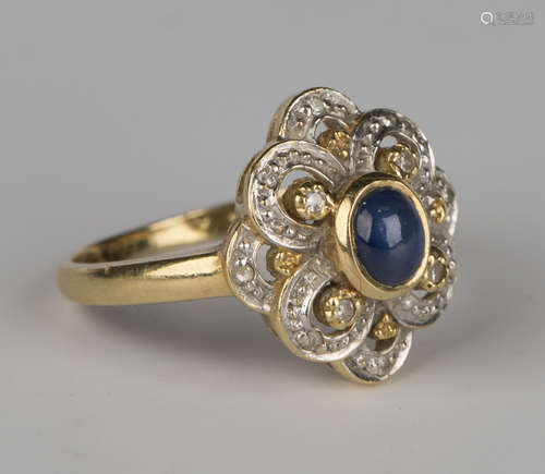 A gold, cabochon sapphire and diamond ring, mounted with the oval cabochon sapphire within a pierced