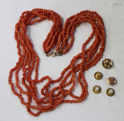 A six row necklace of coral beads on a boltring clasp, length 47.5cm, a pair of gold studs,