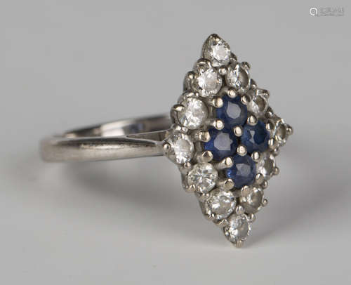 An 18ct white gold, sapphire and diamond lozenge shaped ring, the four central circular cut