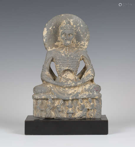 A Gandhara 'Fasting Buddha' grey schist figure, circa 2nd-3rd century AD, finely carved seated in