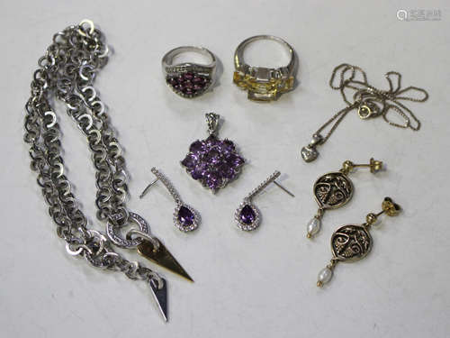 A group of mostly silver jewellery, comprising two pairs of earrings, two rings, an amethyst