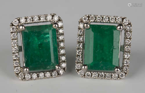 A pair of 18ct white gold, emerald and diamond rectangular cluster earrings, each claw set with a