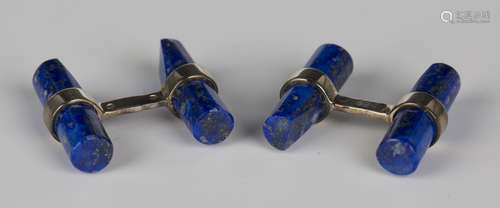 A pair of silver mounted lapis lazuli cufflinks, each back and front of tapered baton shape form,