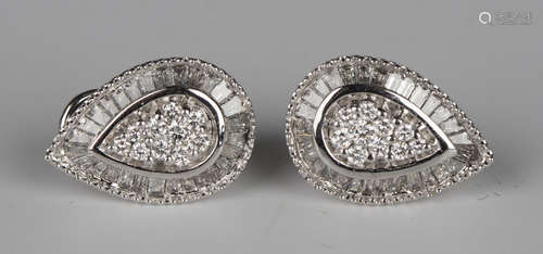 A pair of white gold and diamond drop shaped cluster earrings, each mounted with circular and