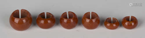 A group of six scarce Ancient Egyptian red glass hair rings, New Kingdom period, circa 1500-1000 BC,