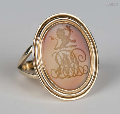 A gold and oval agate intaglio ring, seal engraved with a lion crest above a monogram, remounted