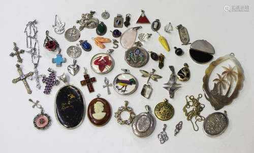 A collection of fifty pendants, lockets and charms, including a small egg shaped pendant, a dragon