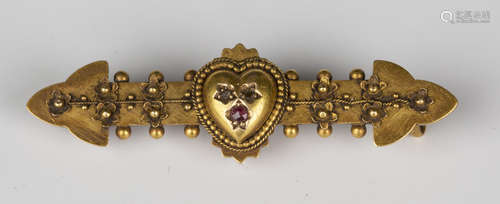 A gold, diamond and ruby bar brooch, the centre with a heart shaped motif, otherwise with beaded